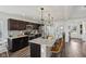 Open kitchen with granite counters, a breakfast bar, and a view to the entryway at 1414 W Springhurst Blvd, Greenfield, IN 46140