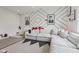 Spacious living area with a modern sofa, unique wall decor, and a playful ' area at 1414 W Springhurst Blvd, Greenfield, IN 46140