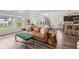 Bright and airy living area with hardwood floors, large windows, and views into the dining and kitchen areas at 1414 W Springhurst Blvd, Greenfield, IN 46140