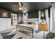 Stylish main bedroom with a barn door leading to the bathroom, decorative black ceiling, and a ceiling fan at 1414 W Springhurst Blvd, Greenfield, IN 46140