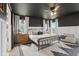 Spacious main bedroom with a decorative black ceiling, white wainscoting, a ceiling fan, and large windows at 1414 W Springhurst Blvd, Greenfield, IN 46140