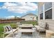 Inviting backyard patio with comfortable seating and a modern fire pit, set against a well-manicured lawn at 1414 W Springhurst Blvd, Greenfield, IN 46140