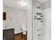 This bathroom includes a vanity, toilet, and a shower-tub with shelves at 1418 W 5Th St, Anderson, IN 46016