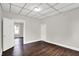 A bedroom shows a window for natural light, painted walls, and dark wood floors at 1418 W 5Th St, Anderson, IN 46016