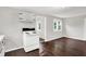 An open-concept kitchen features white appliances, painted walls, and dark wood floors at 1418 W 5Th St, Anderson, IN 46016