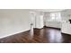 Functional kitchen featuring white appliances, matching cabinets, contrasting countertops, and hardwood flooring at 1418 W 5Th St, Anderson, IN 46016