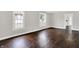 Inviting living room with hardwood floors, gray walls, white trim, and windows that bring in natural lighting at 1418 W 5Th St, Anderson, IN 46016