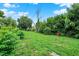 Wide shot of lush, green backyard enclosed by mature trees, shrubs, and foliage at 1418 W 5Th St, Anderson, IN 46016
