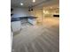 Finished basement showcases a modern bar with a distinctive countertop, complemented by fresh carpeting at 14375 Leland Muse, Fishers, IN 46037