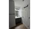 Bathroom features a vanity with granite countertop, dark fixtures, and a door with coat hooks at 14375 Leland Muse, Fishers, IN 46037