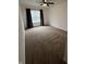 Bright bedroom with neutral carpet, ceiling fan, and window with dark curtains at 14375 Leland Muse, Fishers, IN 46037