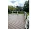 A well-maintained deck with white railings overlooks a lush, green yard, providing a serene outdoor space at 14375 Leland Muse, Fishers, IN 46037