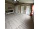 Spacious living room with plush carpet, an electric fireplace, and three access doors at 14375 Leland Muse, Fishers, IN 46037