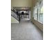 Living area showcasing a staircase and a view of the kitchen with white cabinets and a center island at 14375 Leland Muse, Fishers, IN 46037
