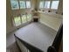 View from staircase overlooking a large living room with tile flooring, large windows and fireplace at 14375 Leland Muse, Fishers, IN 46037