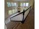 View from staircase overlooking a large living room with tile flooring, large windows and fireplace at 14375 Leland Muse, Fishers, IN 46037