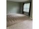 Inviting living room featuring neutral carpet, light green walls, and a large window offering natural light at 14375 Leland Muse, Fishers, IN 46037
