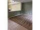 Cozy living space showcasing neutral carpet, light green walls, and a partial view of the yellow living room at 14375 Leland Muse, Fishers, IN 46037