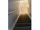 Carpeted stairs with white trim, leading down into the basement with a handrail on the left side at 14375 Leland Muse, Fishers, IN 46037