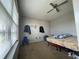 Cozy bedroom featuring carpet, single bed, and a bright sunny window at 1503 Quinlan Ct, Indianapolis, IN 46217