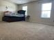 Bright bedroom featuring carpet and a bed with large window views at 1503 Quinlan Ct, Indianapolis, IN 46217