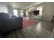 Spacious living room with modern flooring, a cozy fireplace, and a large television at 1503 Quinlan Ct, Indianapolis, IN 46217