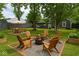 Lush backyard with a fire pit, comfortable Adirondack chairs, and a cozy hammock for relaxing at 1504 Manhattan Ave, Indianapolis, IN 46241