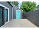 Cozy backyard features a sliding door, turquoise door and privacy fence at 1504 Manhattan Ave, Indianapolis, IN 46241