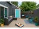 Stylish backyard patio features comfortable seating, string lights, and a fun cornhole game at 1504 Manhattan Ave, Indianapolis, IN 46241