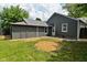 Back of house with a small shed, backyard with grass, and newly shingled roof at 1504 Manhattan Ave, Indianapolis, IN 46241