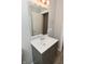 Bathroom vanity featuring grey cabinets, a white countertop and sink, a large mirror, and modern lighting at 1504 Manhattan Ave, Indianapolis, IN 46241