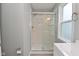 Bright bathroom featuring a glass shower, subway tile, modern vanity and natural light at 1504 Manhattan Ave, Indianapolis, IN 46241