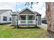 Charming single-story home showcasing a covered porch, gray siding, and a manicured lawn at 1504 Manhattan Ave, Indianapolis, IN 46241