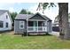 Charming single-story home showcasing a covered porch, gray siding, and a manicured lawn at 1504 Manhattan Ave, Indianapolis, IN 46241