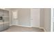 Bright kitchen area with stainless steel refrigerator, door to backyard and a view of neutral walls and wood look floors at 1504 Manhattan Ave, Indianapolis, IN 46241