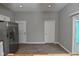 Open concept kitchen and dining area, adjacent to stainless steel refrigerator, with light gray walls at 1504 Manhattan Ave, Indianapolis, IN 46241