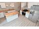 Airy kitchen with stainless steel appliances, butcher block countertops, an island, and white cabinets at 1504 Manhattan Ave, Indianapolis, IN 46241