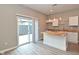 Bright kitchen features white cabinets, butcher block counters, an island, and sliding doors to the outside at 1504 Manhattan Ave, Indianapolis, IN 46241
