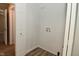 Bright laundry room with connections and outlets for a washing machine and dryer, wood look flooring, and a view to hallway at 1504 Manhattan Ave, Indianapolis, IN 46241