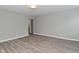 Empty living room featuring gray walls, luxury vinyl plank flooring, and an open archway leading to another room at 1504 Manhattan Ave, Indianapolis, IN 46241