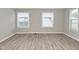 Spacious living room with three large windows provides ample natural light and enhances the hardwood style flooring at 1504 Manhattan Ave, Indianapolis, IN 46241