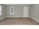 Bright living room with a window and door offers an open space with luxury vinyl plank flooring at 1504 Manhattan Ave, Indianapolis, IN 46241