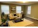 Comfortable living room with neutral-toned walls, plush sofa, and natural light from the windows at 1504 Manhattan Ave, Indianapolis, IN 46241