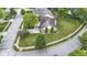 Aerial view of a brick home with a well-maintained lawn, landscaping, and neighboring pergola-covered deck at 15098 Newburyport Dr, Fortville, IN 46040