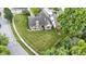 Aerial view of a brick home with a well-maintained lawn, landscaping, and neighboring pergola-covered deck at 15098 Newburyport Dr, Fortville, IN 46040