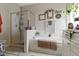 Bright bathroom featuring a separate shower, bathtub, and decorative vines around the room at 15098 Newburyport Dr, Fortville, IN 46040