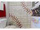 Neutral bathroom with baseball themed shower curtain at 15098 Newburyport Dr, Fortville, IN 46040