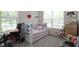 Cozy bedroom with carpet, large window, and stuffed animal decor at 15098 Newburyport Dr, Fortville, IN 46040