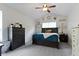 Cozy bedroom featuring neutral walls, carpet, a ceiling fan and dark-toned furniture at 15098 Newburyport Dr, Fortville, IN 46040