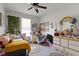 Comfortable bedroom with a window, ceiling fan, dresser, and a bed with a yellow comforter at 15098 Newburyport Dr, Fortville, IN 46040